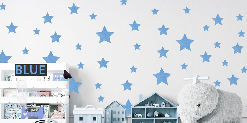 Blue star wall decal stickers on a white wall, perfect for adding a playful touch to kids' rooms or nurseries.
