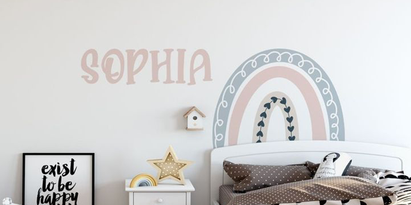 Pastel rainbow wall sticker with heart accents and "Sophia" text, decorated with balloons and a star ornament.
