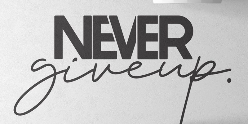 Black and white motivational wall art with bold "Never give up" text in mixed fonts, adding inspiration to any space.