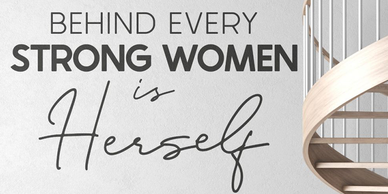 Wall decal with the quote "Behind every strong woman is herself," designed to inspire empowerment and strength.