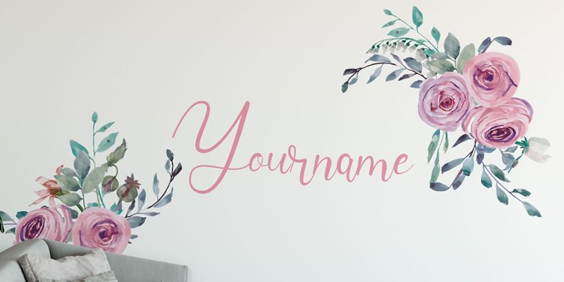 Customizable wall decal with pink floral accents and script font for a personalized name, perfect for adding elegant décor to any room.