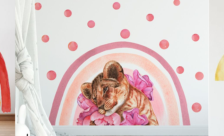 A trio of wall art featuring a colorful rainbow, pink polka dots with an animal, and a geometric abstract design with plants.