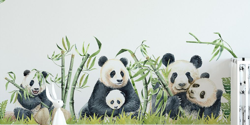 Adorable panda family wall stickers featuring pandas sitting among bamboo, perfect for decorating children's rooms.