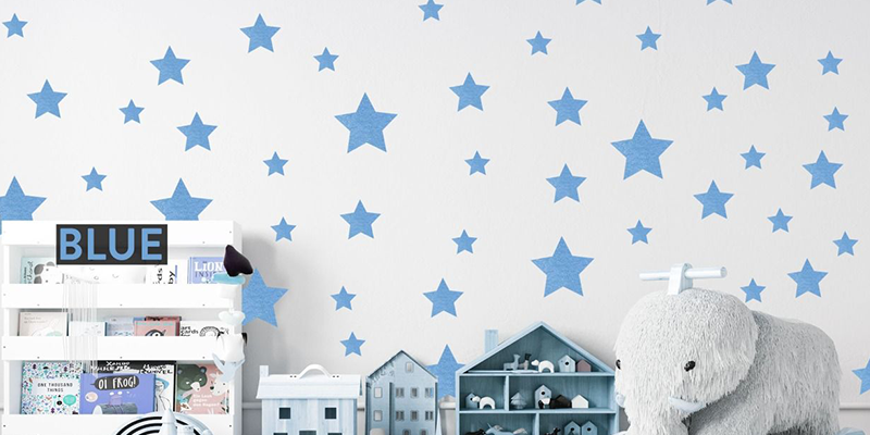 Bedroom wall decorations featuring blue star decals, toy elephant, and shelves with kids' items. Perfect for playful decor.