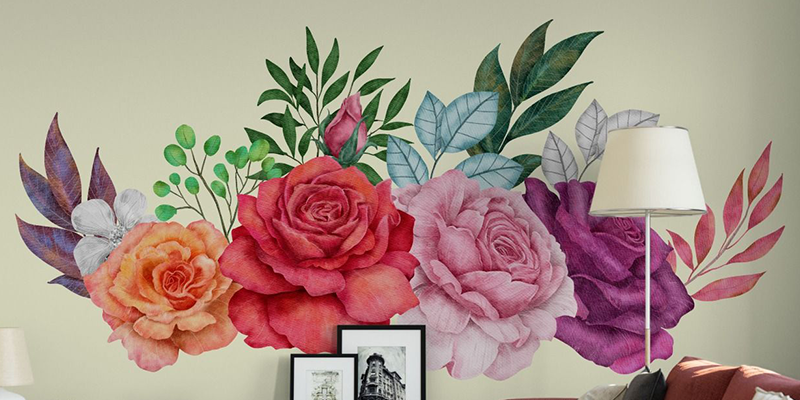 Vibrant watercolor-style wall decals of large roses and leaves in various colors, creating a stunning floral accent on the wall.