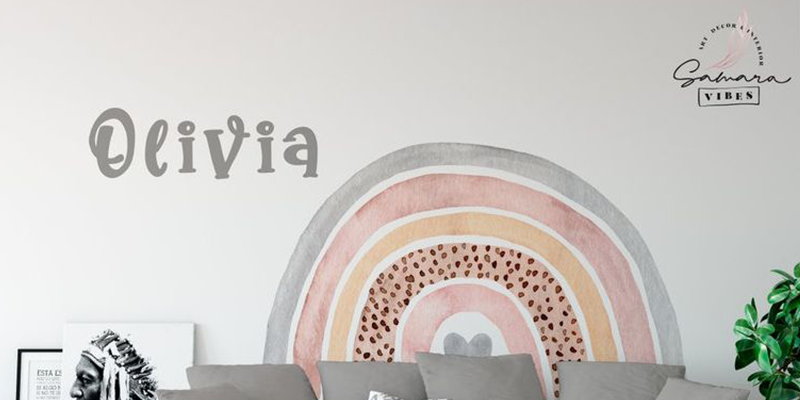 Boho wall decal featuring a soft, earthy-toned rainbow with customizable name text, perfect for personalizing living spaces.