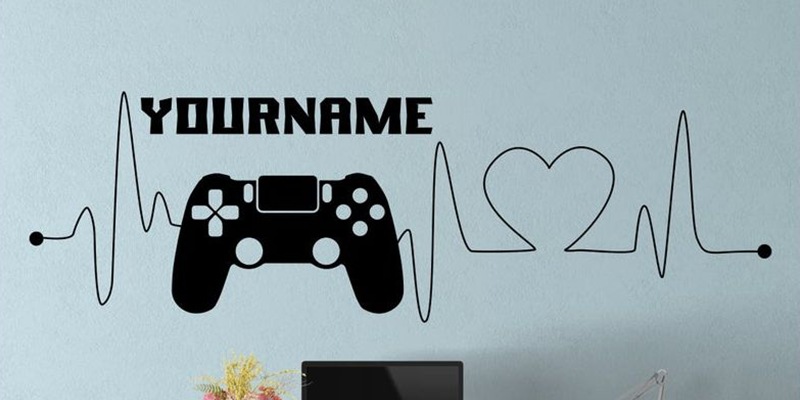Black gamer wall decal for kids featuring a controller, heartbeat line, and customizable name. Great for gaming-themed rooms.