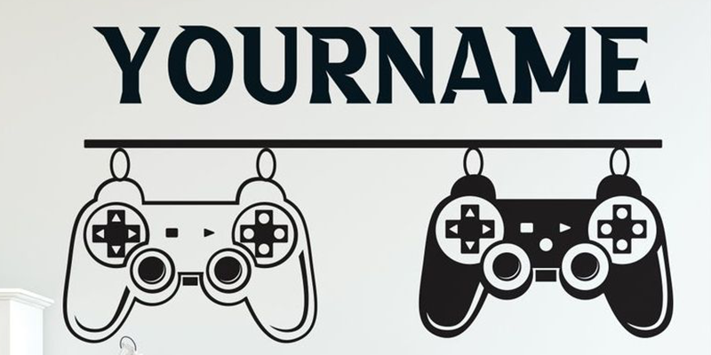 Gamer wall decal featuring two hanging game controllers with space for a personalized name above in bold text.