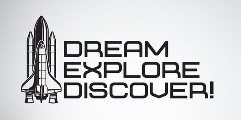 Space wall sticker with a rocket illustration next to the words "Dream, Explore, Discover!" in bold black text.
