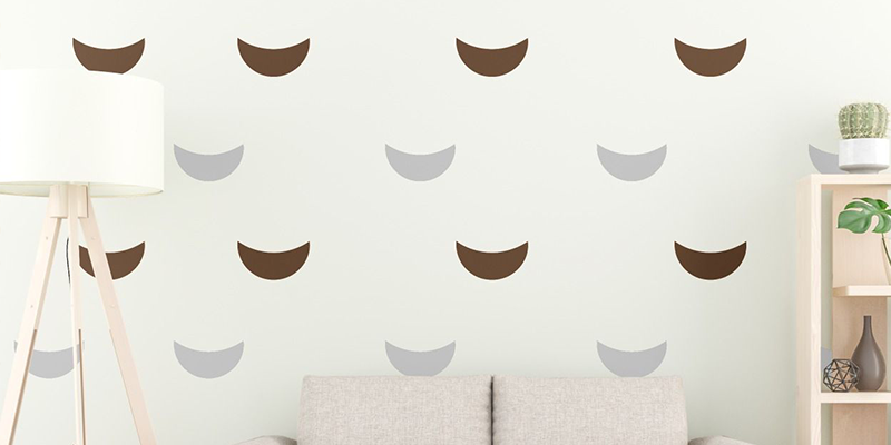 Brown and gray crescent-shaped Boho wall stickers on a white wall, adding a subtle decorative touch to modern interiors.