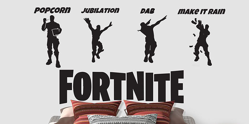 Black silhouette Fortnite wall stickers showing emotes like Popcorn, Jubilation, Dab, and Make It Rain above a bed.