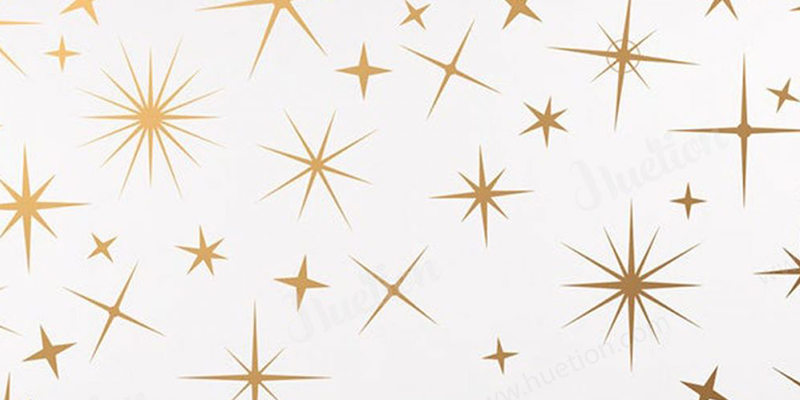 Gold starburst and star-shaped pattern on a white background, adding a celestial touch to boho decor style.