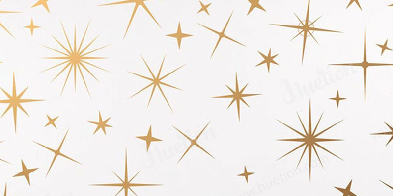 Gold starburst and star-shaped pattern on a white background, adding a celestial touch to boho decor style.