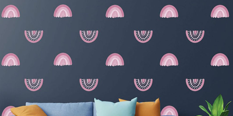 Pink rainbow patterns on a dark navy wall, creating a chic Boho peel and stick wallpaper design for modern interiors.