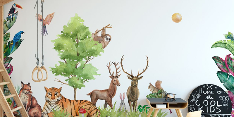 Nursery wall stickers of woodland animals, including deer, a tiger, and birds, surrounding a tree with playful décor.