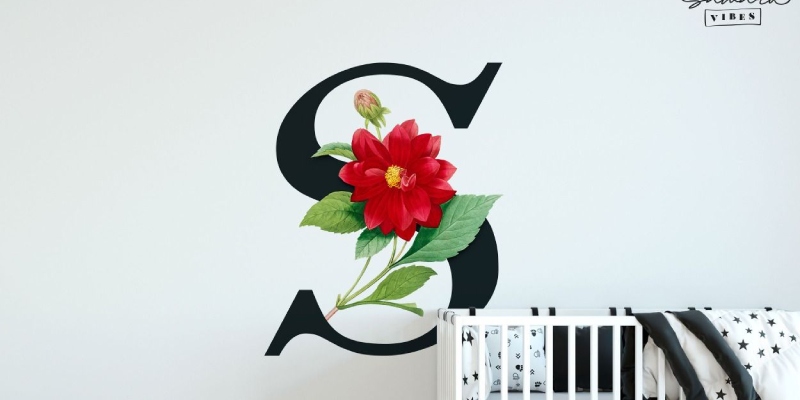 Custom wall decal featuring a bold black letter "S" with a red flower and green leaves, perfect for nursery decor.