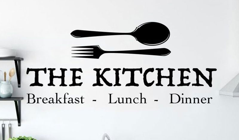Kitchen wall sticker with spoon and fork design featuring the text "The Kitchen: Breakfast, Lunch, Dinner," ideal for decor.