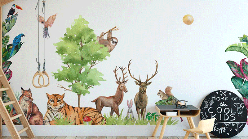 Nursery wall stickers of woodland animals, including deer, a tiger, and birds, surrounding a tree with playful décor.