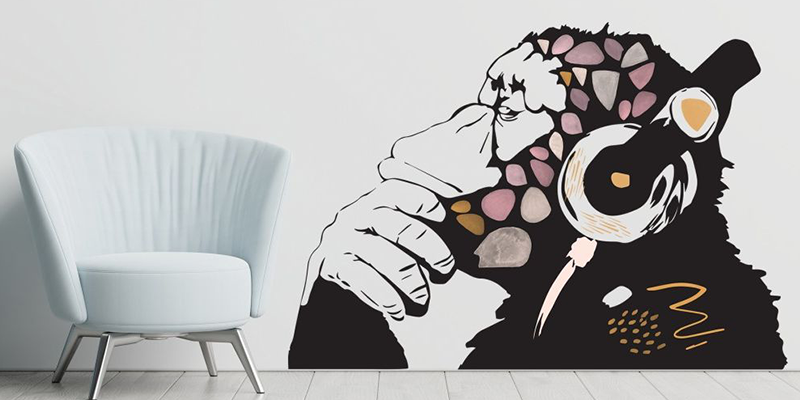 Children's wall sticker featuring a stylized monkey wearing headphones with abstract colorful accents, adding a playful vibe to the room.