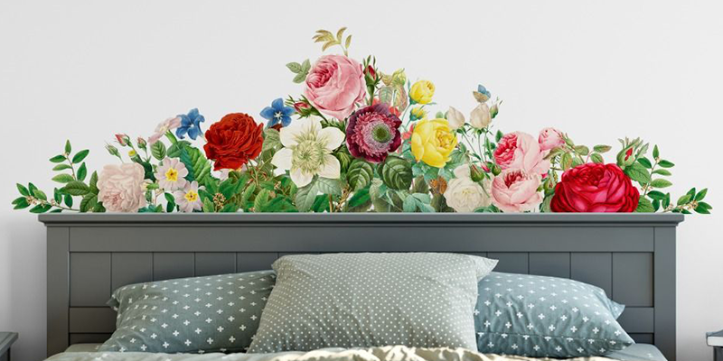 Wall stickers for bedroom featuring a vibrant floral arrangement with roses and greenery above a bed's headboard.