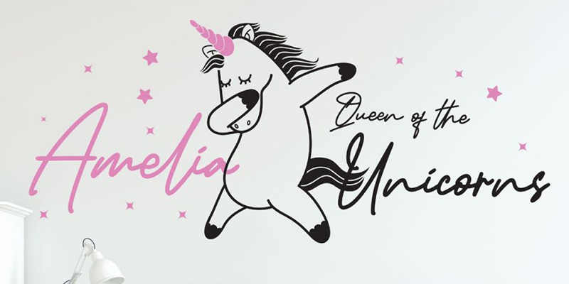 Custom wall decal with a dancing unicorn, pink stars, and personalized "Amelia, Queen of the Unicorns" text for kids' rooms.