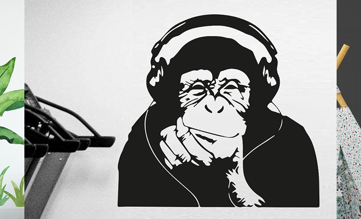 Collection of cute animal wall stickers featuring playful designs of a bear, a thoughtful monkey with headphones, and a lounging sloth on branches.