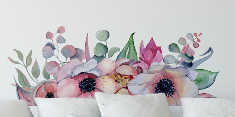 Watercolor-style headboard wall sticker featuring soft pink, purple, and green flowers, adding a delicate touch to bedroom decor.