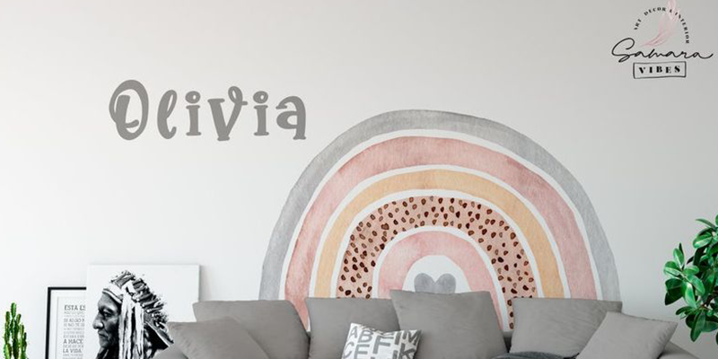 Boho wall decal featuring a soft, earthy-toned rainbow with customizable name text, perfect for personalizing living spaces.