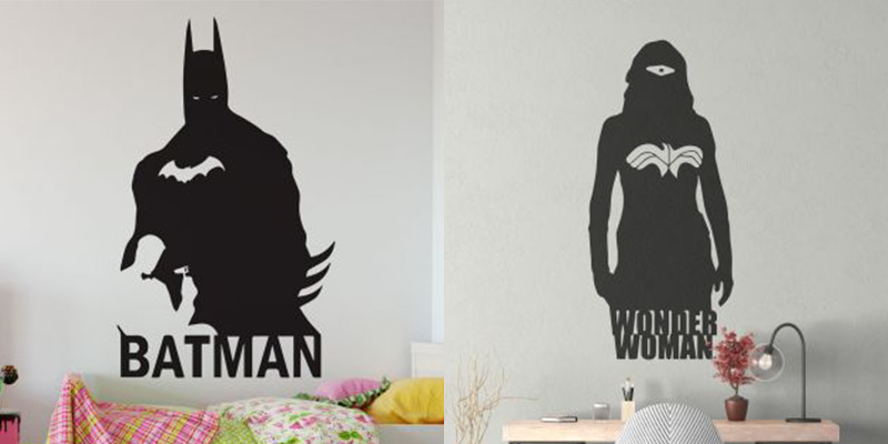 Black silhouette superhero wall stickers of Batman and Wonder Woman, adding bold character accents to kids' room decor.