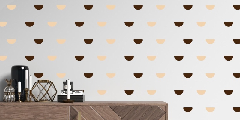 Wall decal featuring a pattern of alternating dark brown and beige half-circles on a light wall, adding a modern touch.