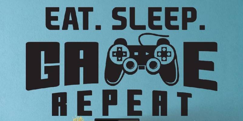 Nursery wall sticker with "Eat. Sleep. Game. Repeat." text and a game controller graphic, ideal for a young gamer's room decor.