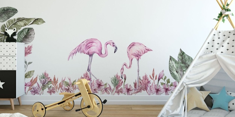 Wall decal featuring two pink flamingos surrounded by tropical plants, creating a vibrant and playful scene.