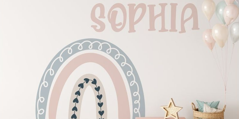 Pastel rainbow wall sticker with heart accents and "Sophia" text, decorated with balloons and a star ornament.