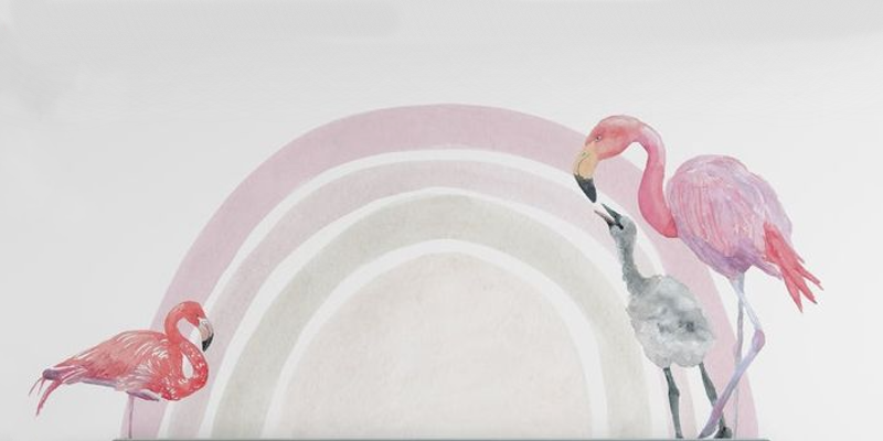 Three flamingos in vibrant pink and gray tones stand in front of a soft pastel rainbow wall sticker design.